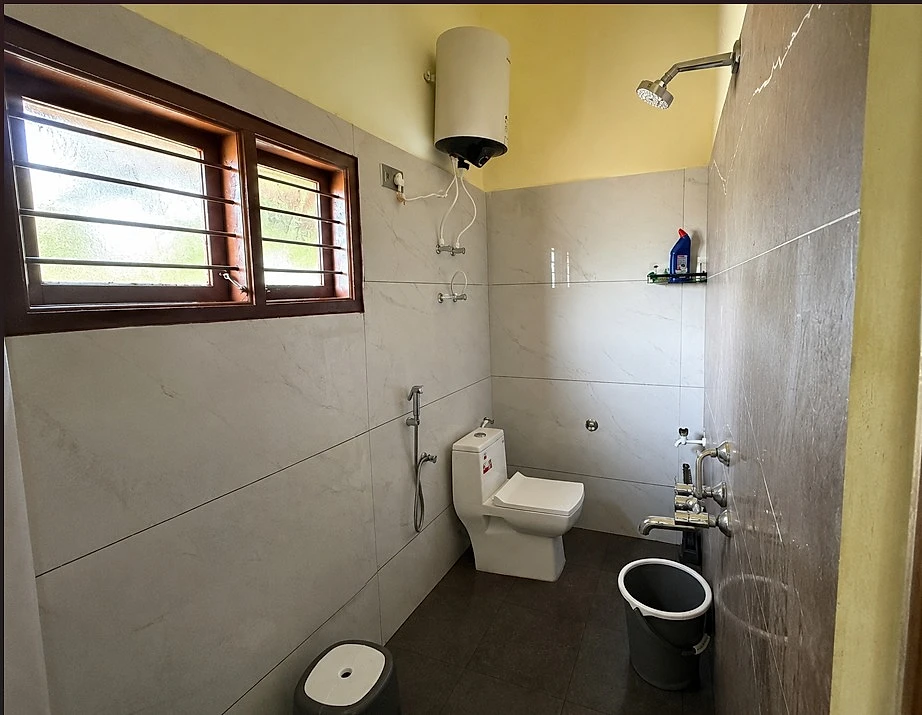 Clean bathroom with hot-water geyser